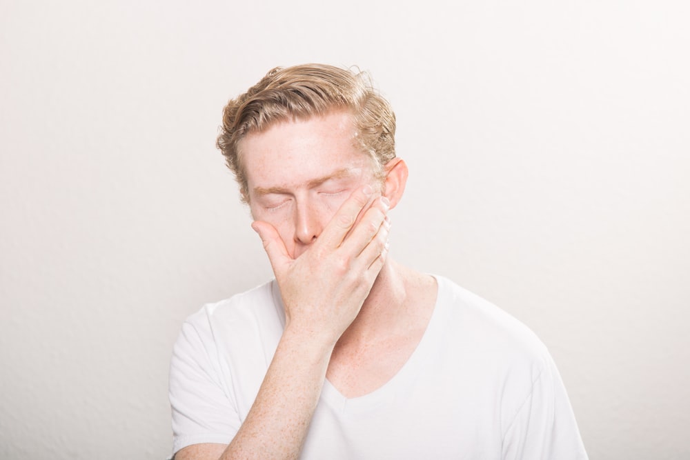 man covering his mouth