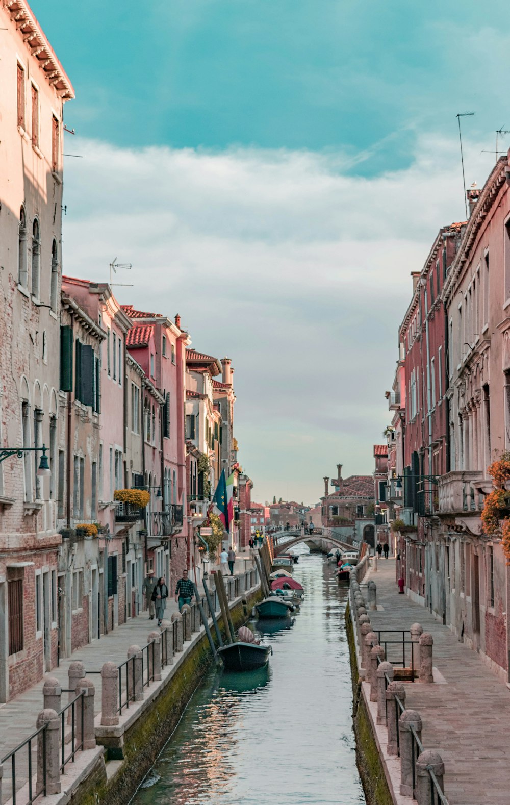 body of water between concrete buildings