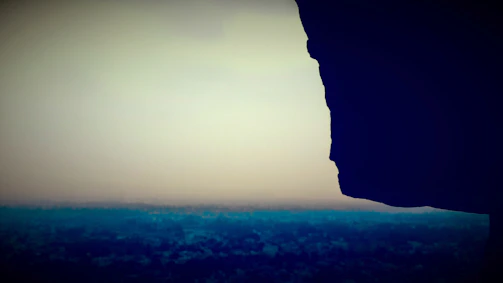 A time-lapse photo showing a rock formation subtly changing shape at dusk.