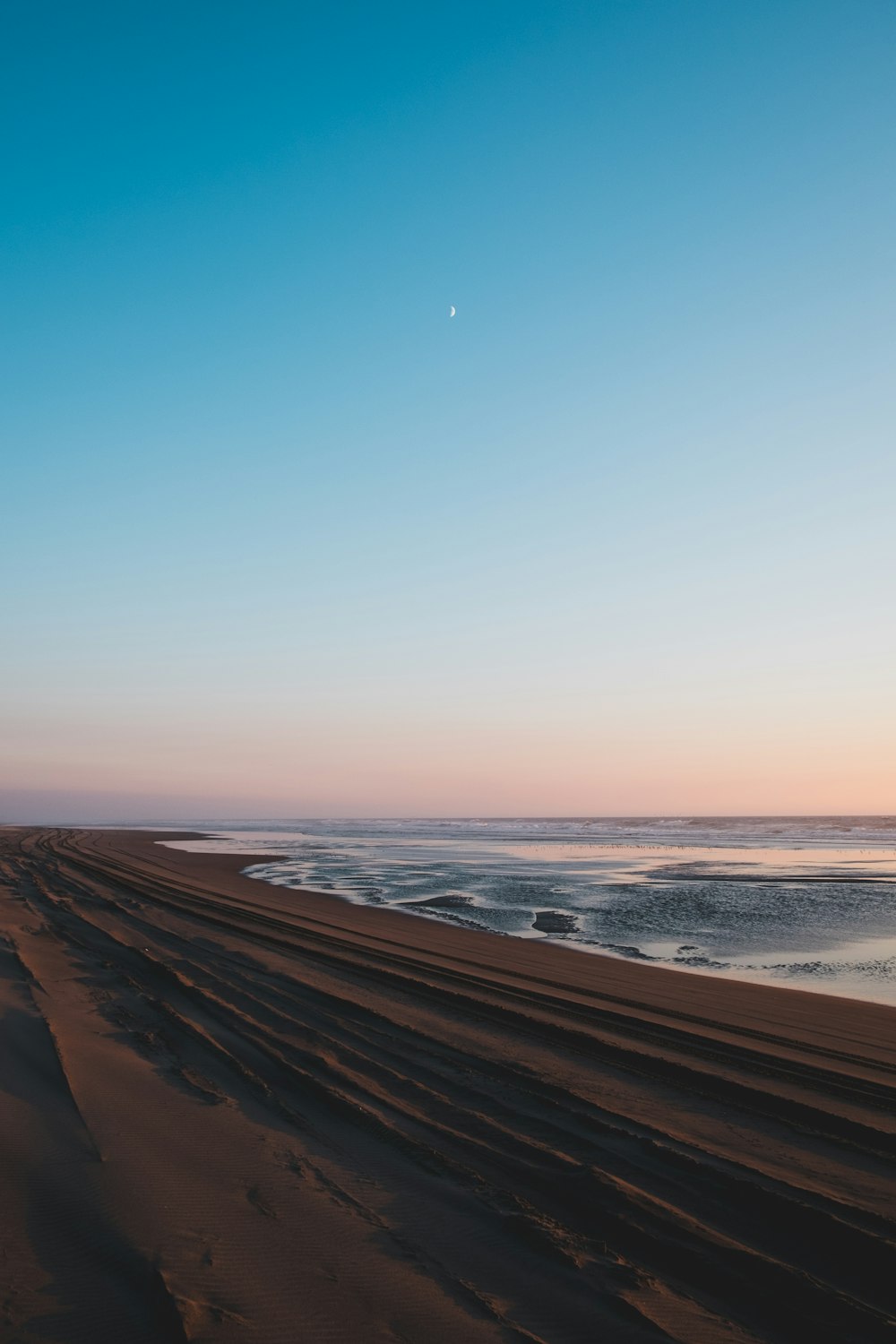 brown sand under blue sky