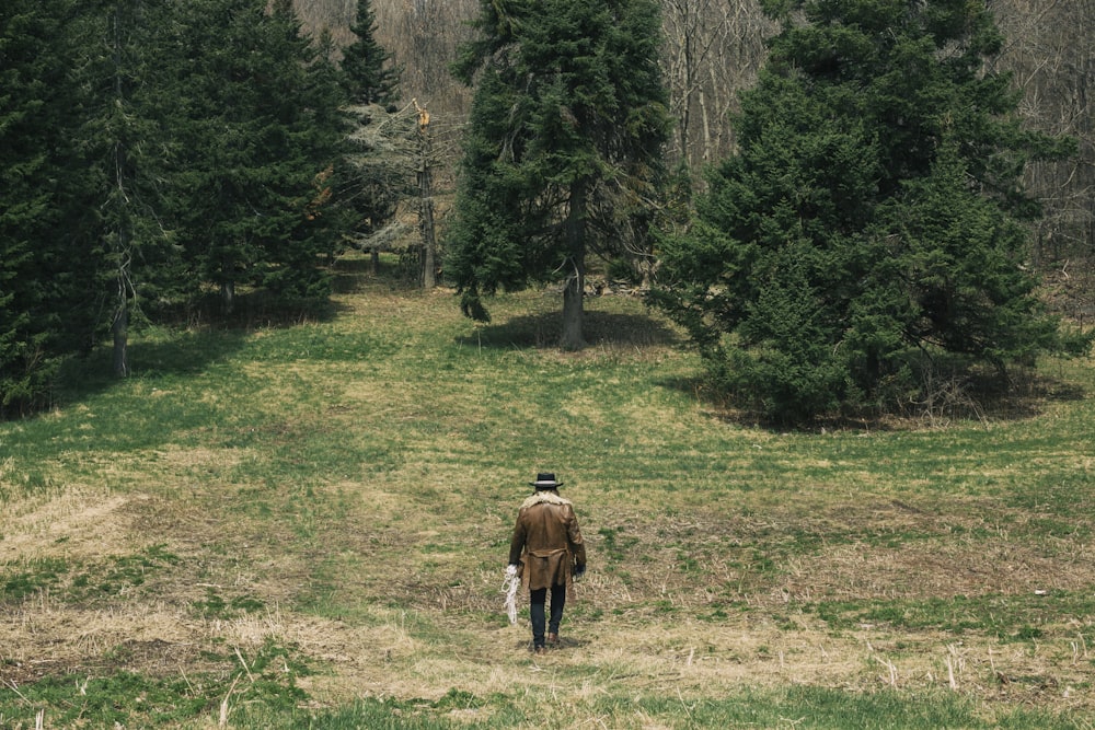 man standing on green grass field