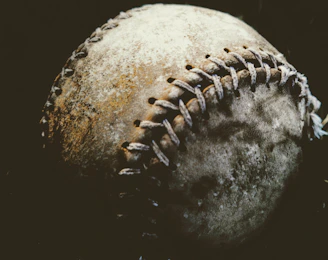 Close-up of worn-in boxing gloves with visible stitching and character.