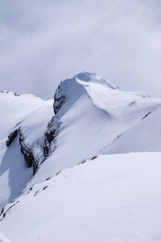 snow-covered mountains under gray sky during daytime in Säntis Switzerland