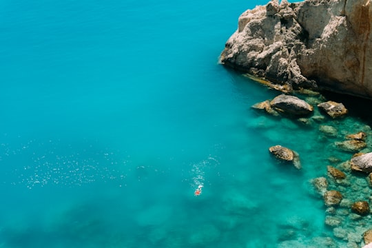 brown rock formation near body of water in Porto Katsiki Greece