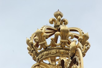 Close-up of the fleur de lis emblem embroidered on an elegant ceremonial robe.