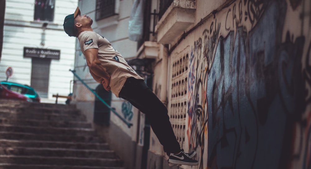 man jumping near wall