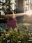 girl sitting on daisy flowerbed in forest