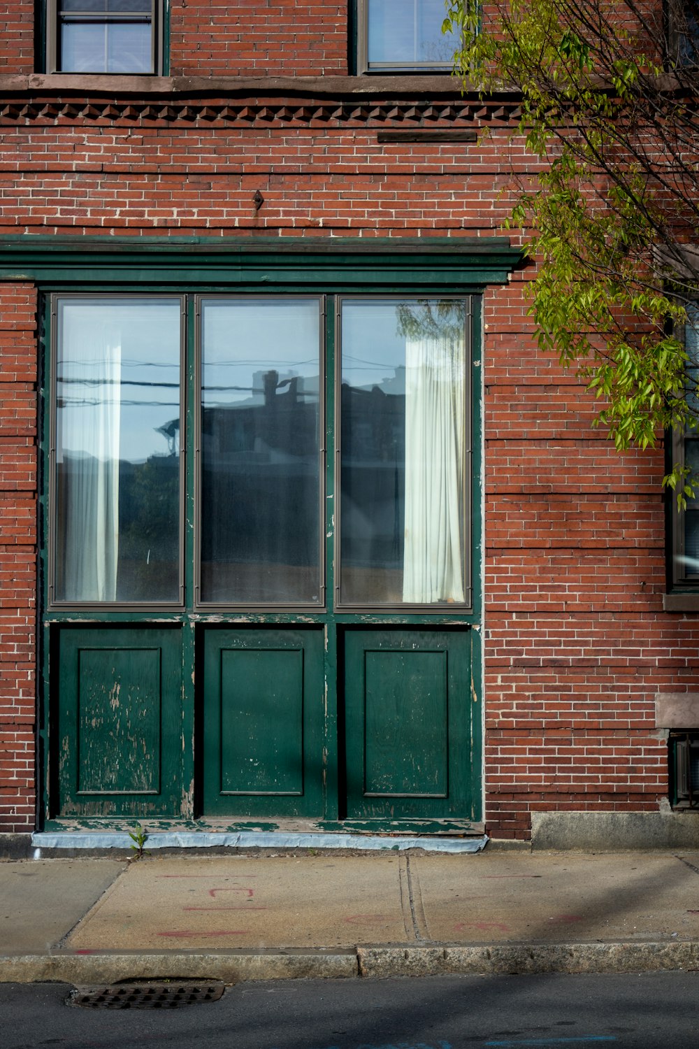 closed glass window with brick wall