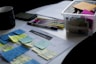 sticky notes on paper document beside pens and box