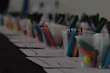 Bright crayons, markers, and paper arranged invitingly on a kid-sized table.