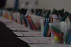 Bright crayons, markers, and paper arranged invitingly on a kid-sized table.