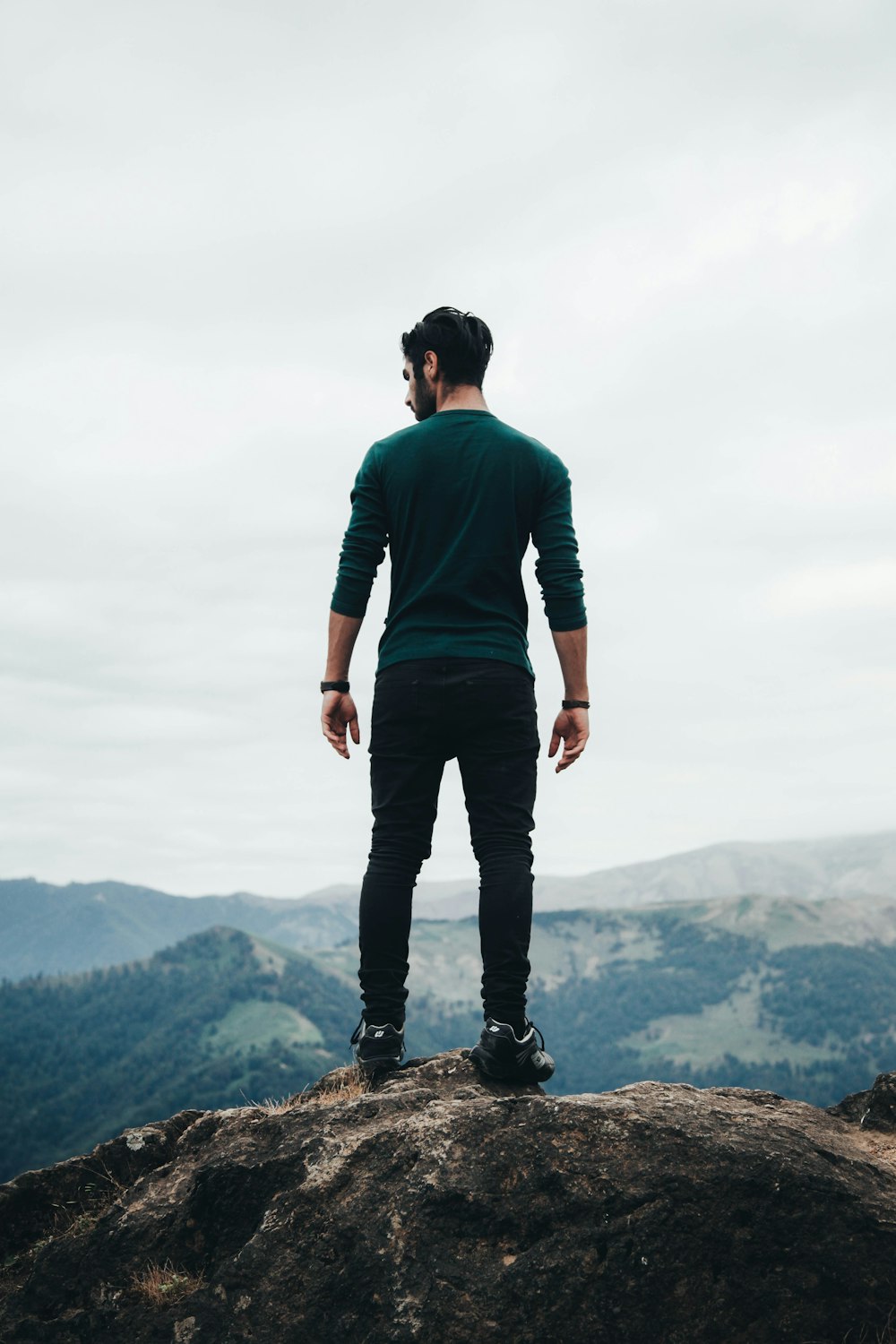 man standing on rock formation