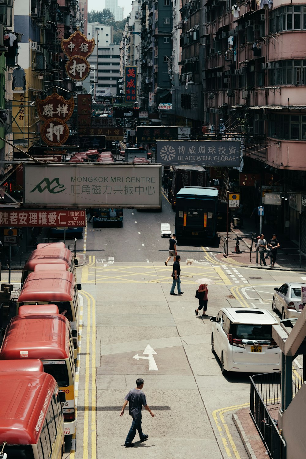 people walking on road near cars during daytime