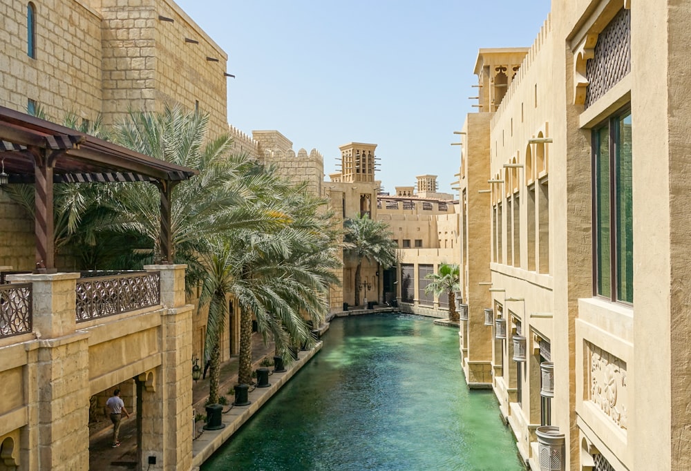 Several large buildings with light yellow stones all around.