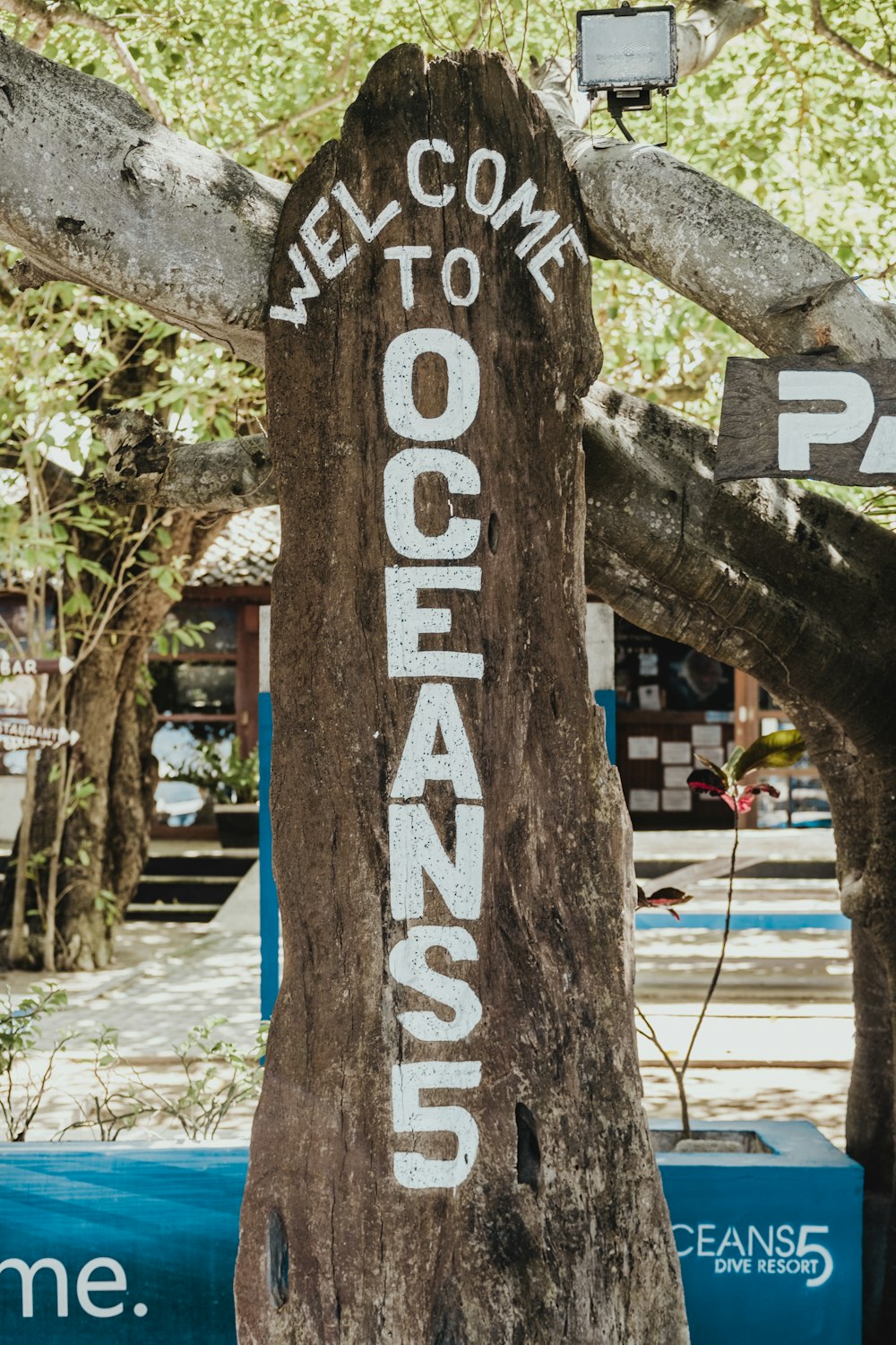 brown welcome to Oceans5 wooden signage