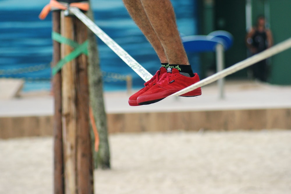 man balancing on white rope