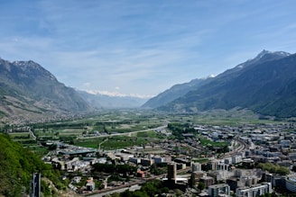 A scenic view of a tranquil valley surrounded by mountains.