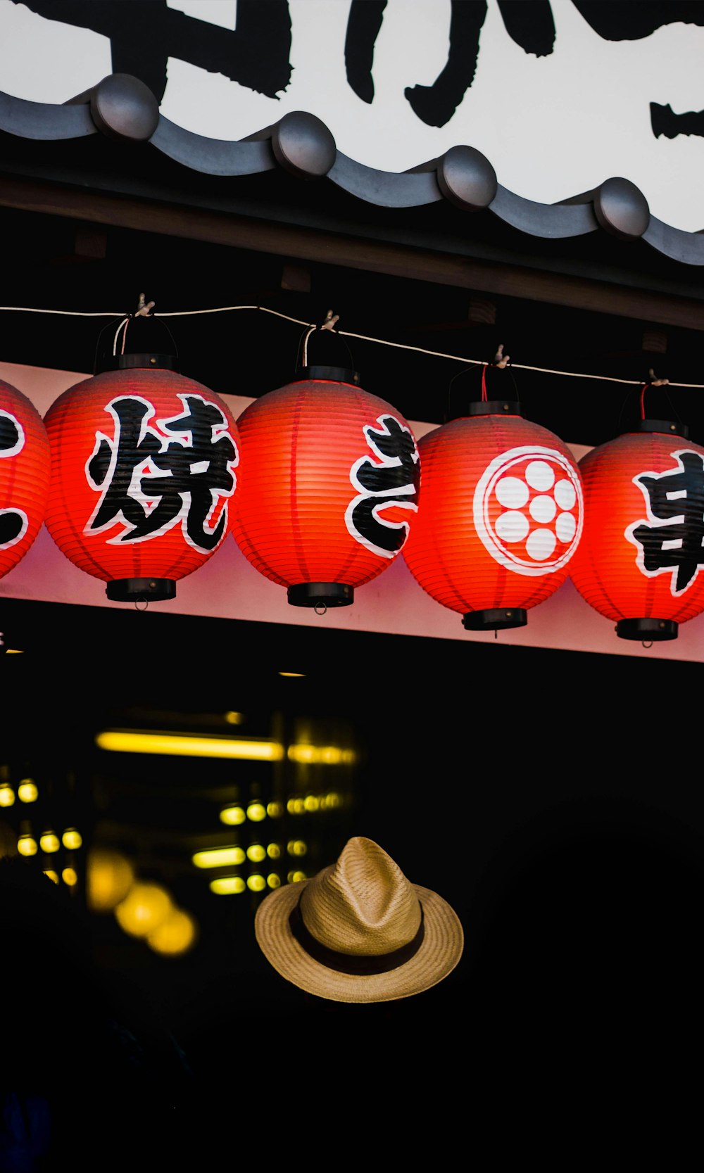 brown hat under lantern lamps