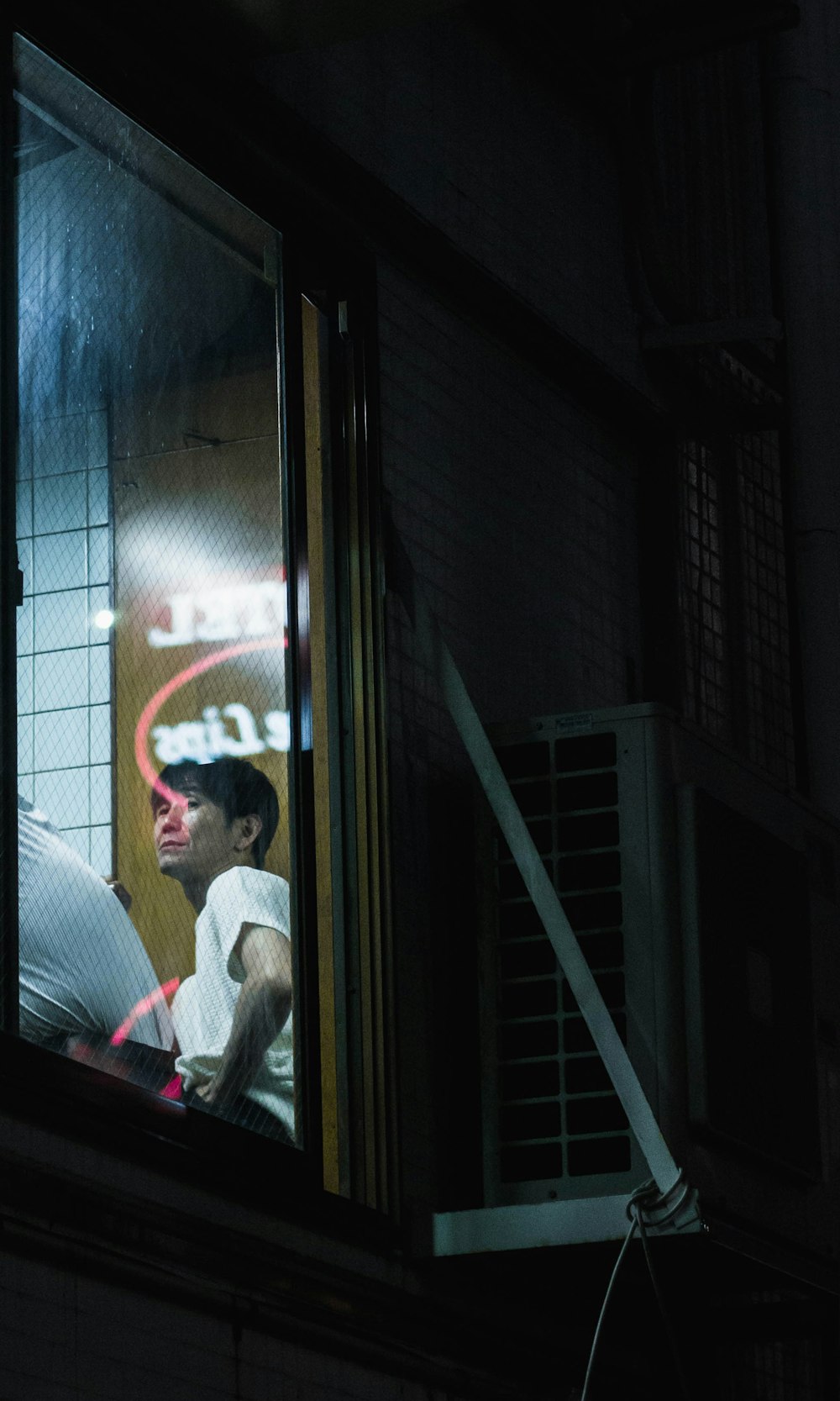 man sitting beside window