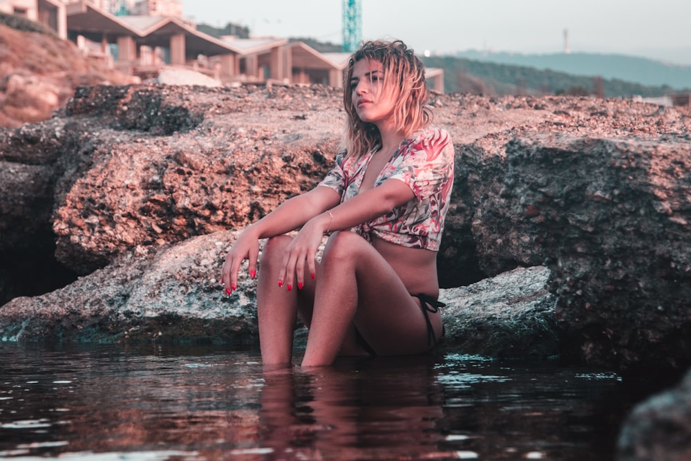 woman sitting on body of water