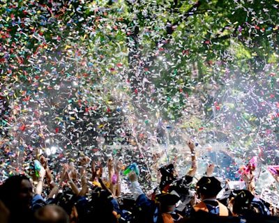 people covered by confetti graduation google meet background