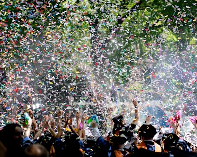 people covered by confetti commencement google meet background