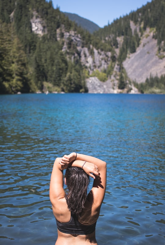 woman facing mountain with pine trees in Chilliwack Lake Provincial Park Canada