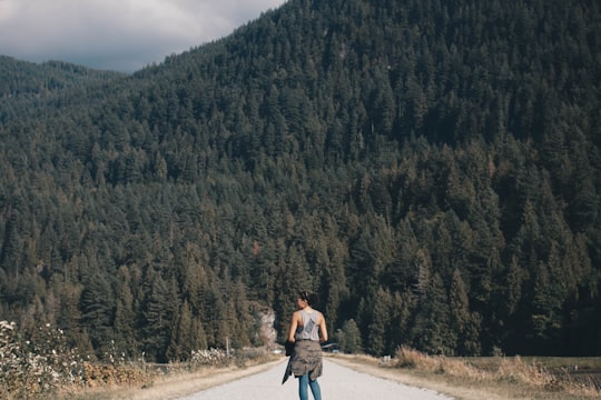 woman walking on road in Pitt Lake Canada