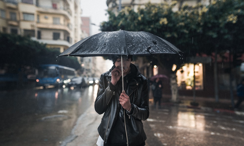 man carrying umbrella