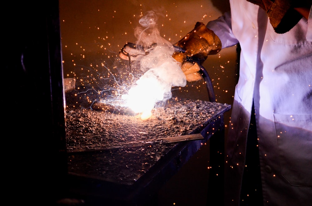 person holding welding machine