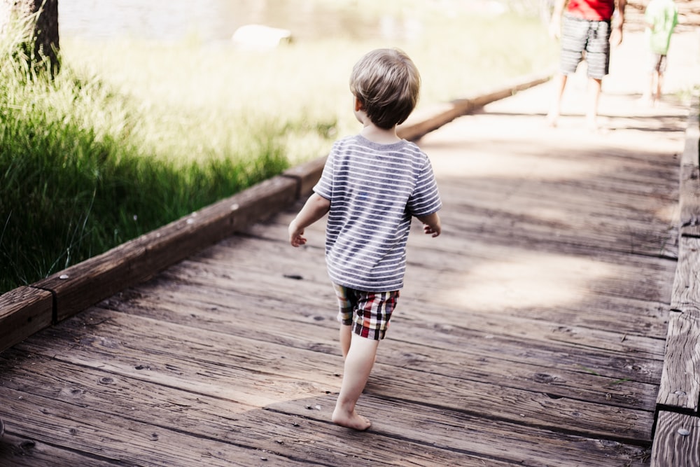 child walking on bridge