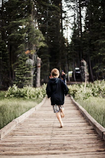 Children running barefoot through the lush grass beside the market garden.