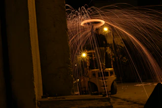 Rider grinding a rail with sparks flying, wheels glowing under neon lights.