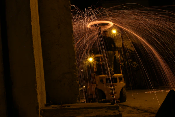 Rider grinding a rail with sparks flying, wheels glowing under neon lights.