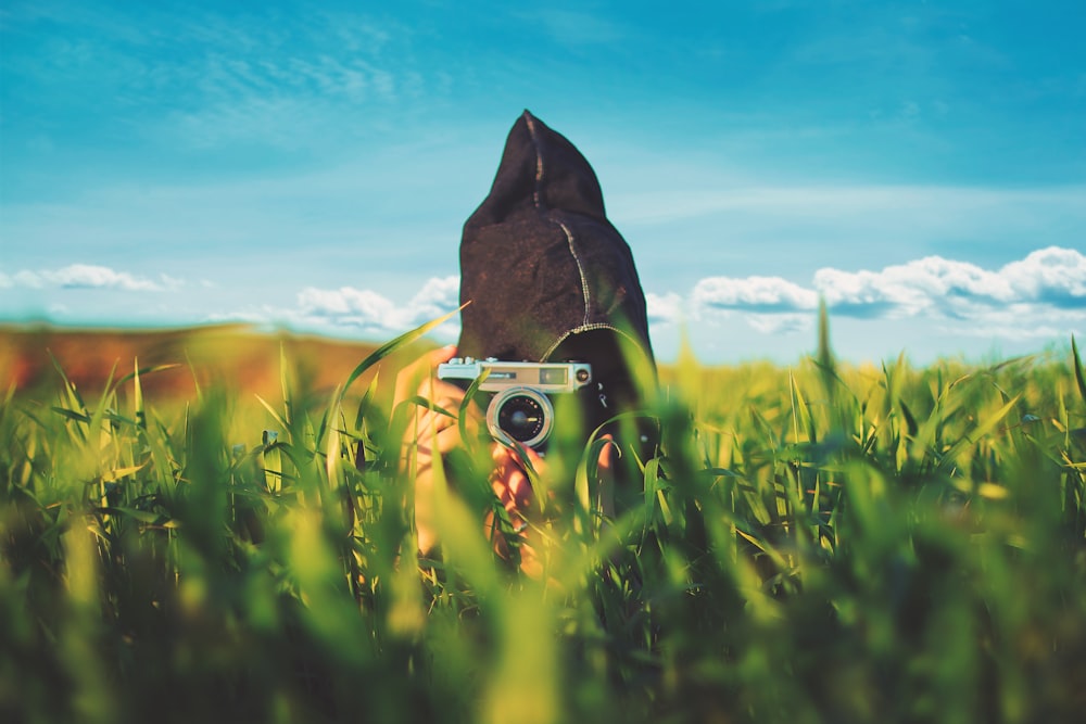 shallow focus photography of person taking photo