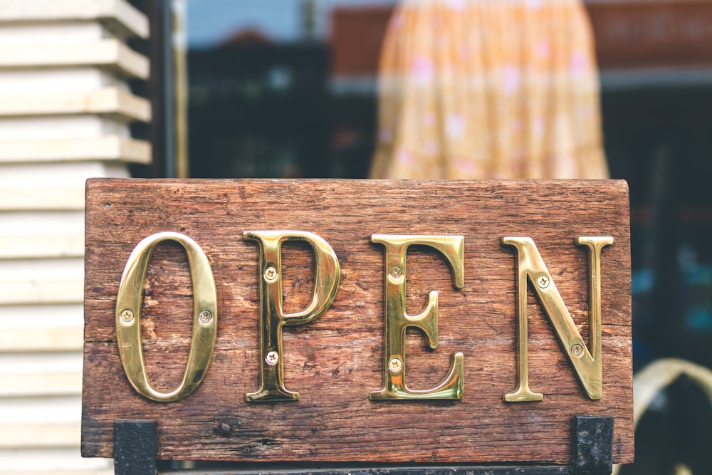 Open-shaped brass signage