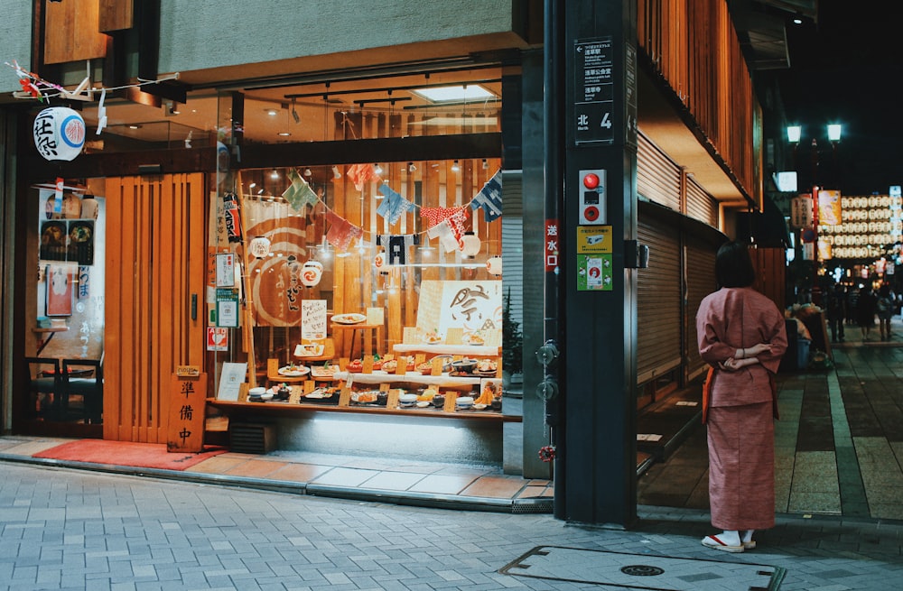 woman standing near cafe