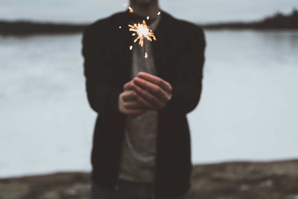 person playing with handheld fireworks