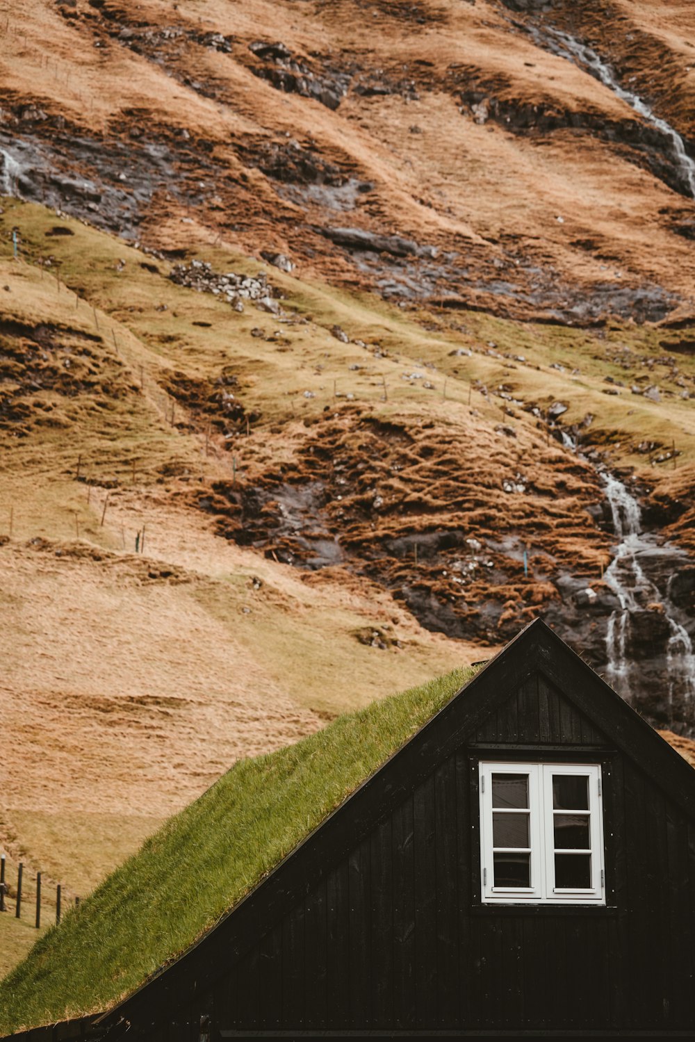 green house beside mountain