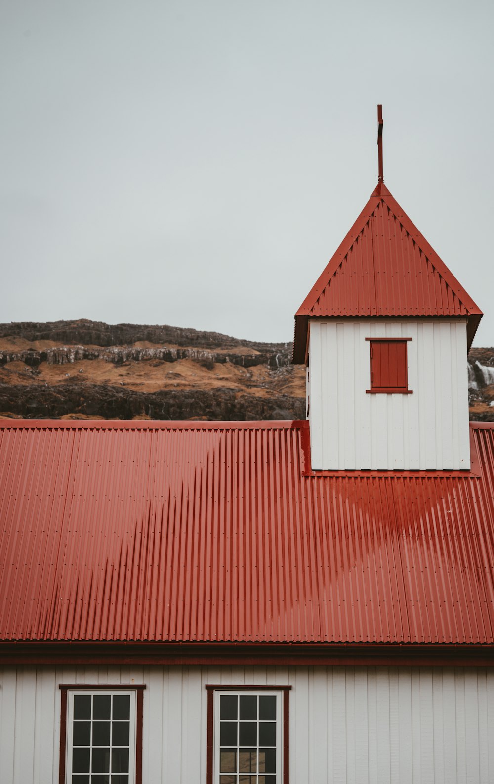 red and white building under cloudy sky during daytime