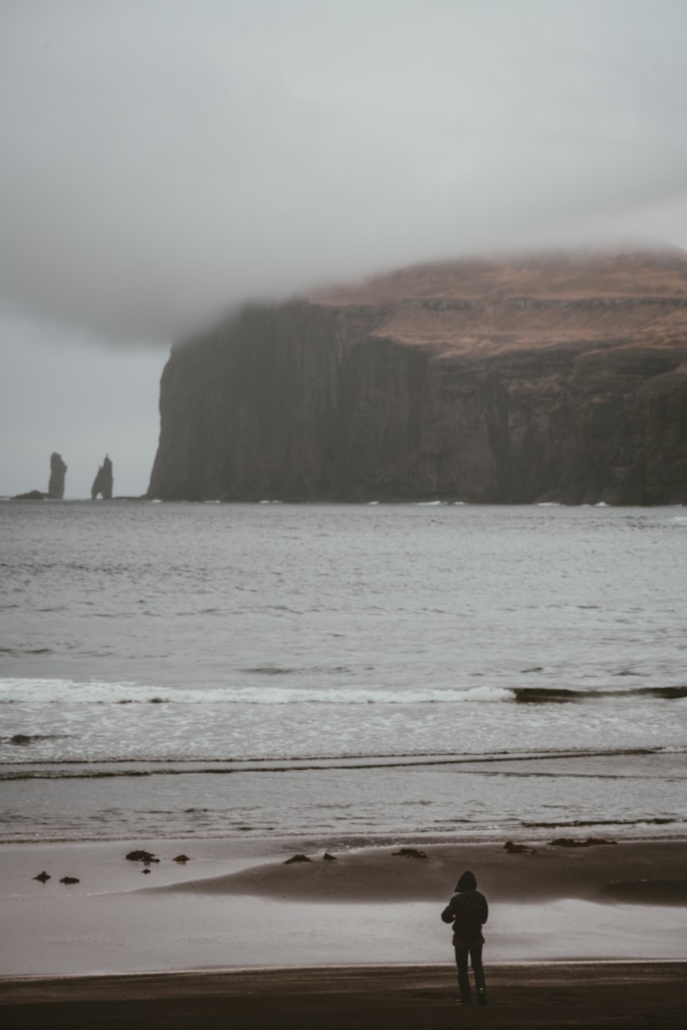 person standing on shoreline