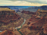 The Colorado River winding through the deep red rock canyons of the Grand Canyon