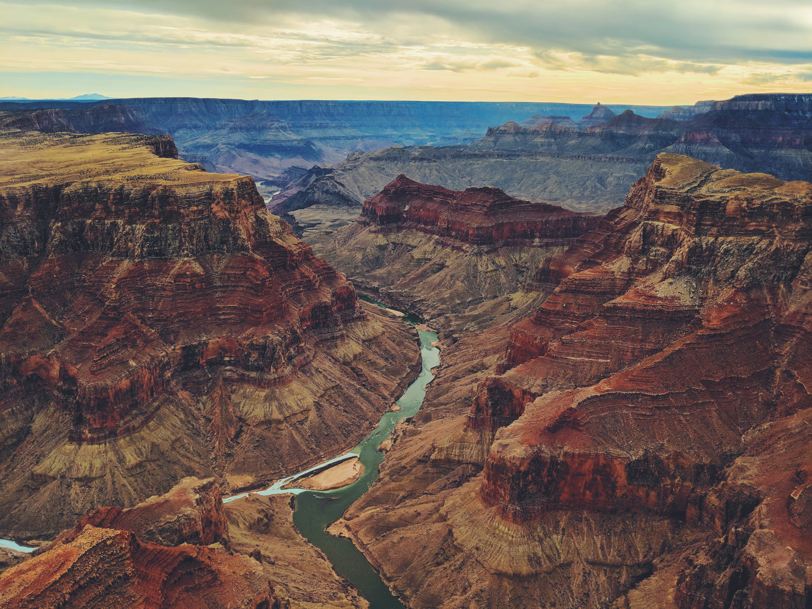 The Colorado river winding through the layered walls of the Grand Canyon