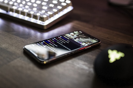 closeup photo of turned on smartphone near keyboard