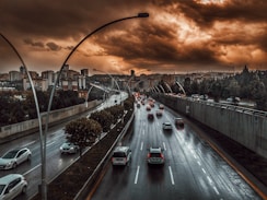 road under brown and black sky during daytime