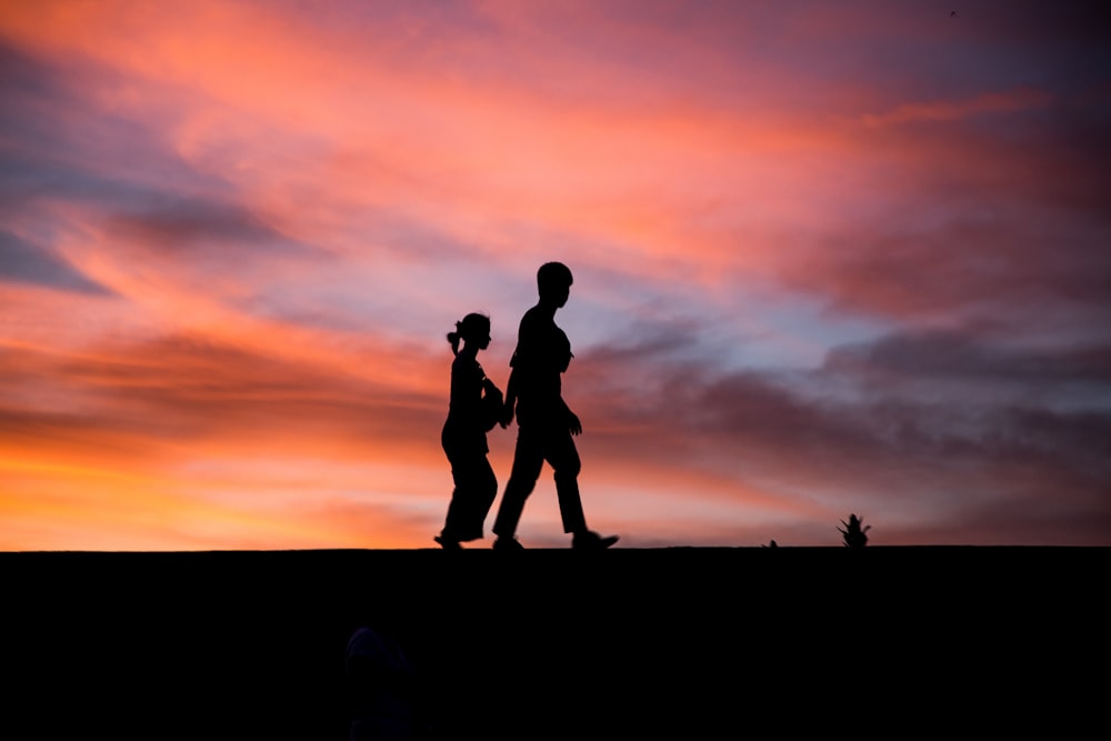 silhouette photography of man and woman