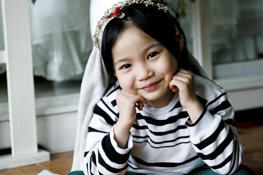 girl in white and black sweater taking photo