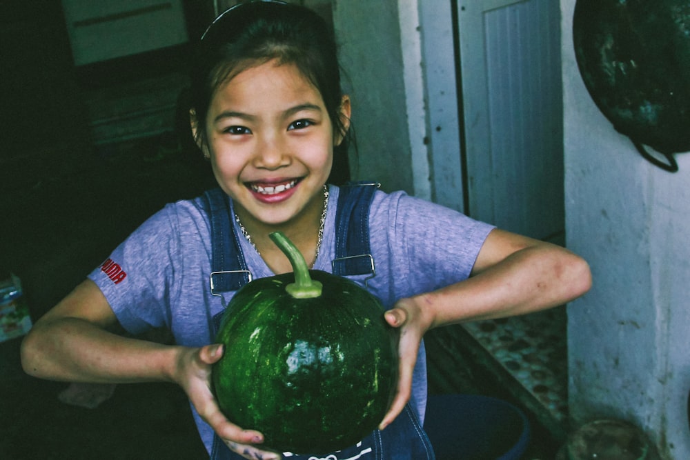girl holding a pumpkin