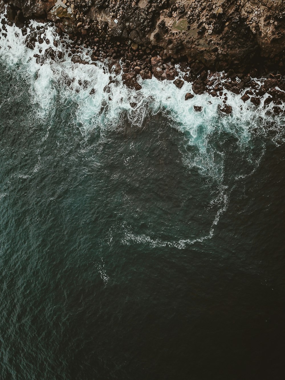 aerial photography of mountain and ocean