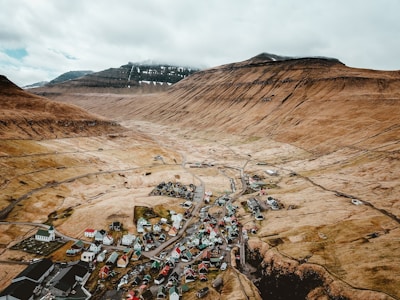 top view photo of houses surrounded by mountain